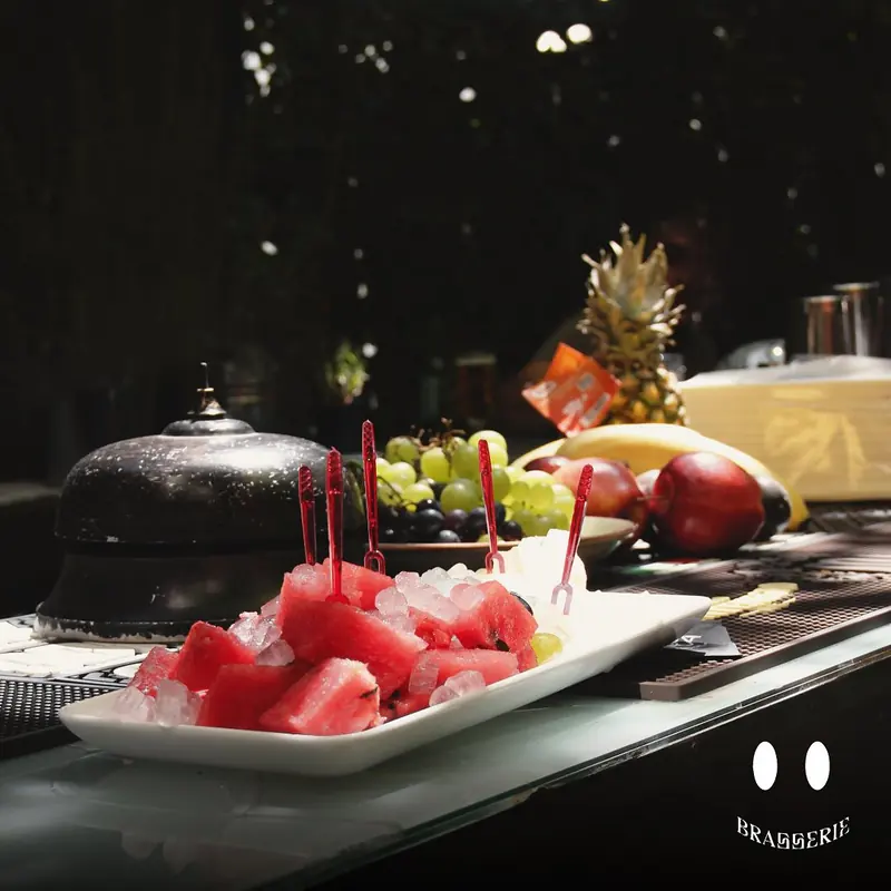 Shalqi i prerë dhe fruta mbi banakun e barit
